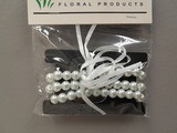 3 Row Pearl Wristlet With Plastic Pad/Ribbon White