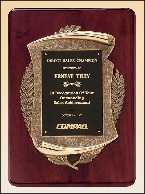 Rosewood stained piano finish plaque with an antique bronze finished frame casting