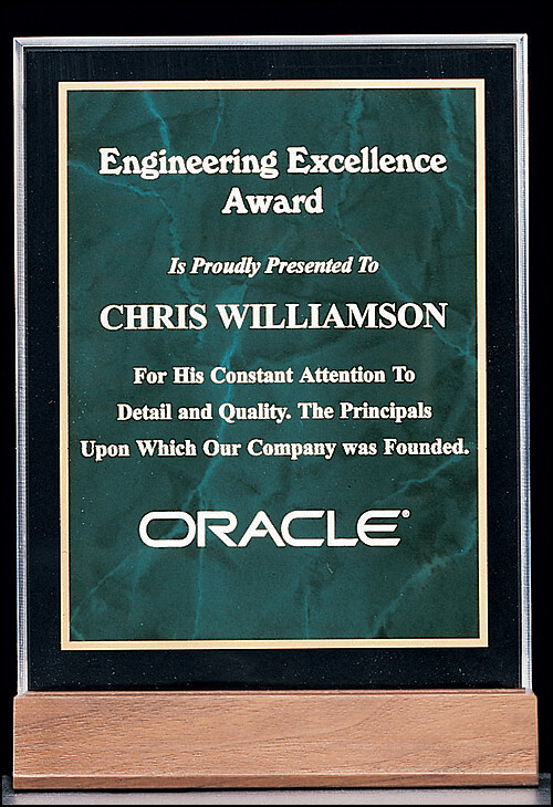 3/4" thick polished acrylic award with an emerald marble center on a solid American walnut base