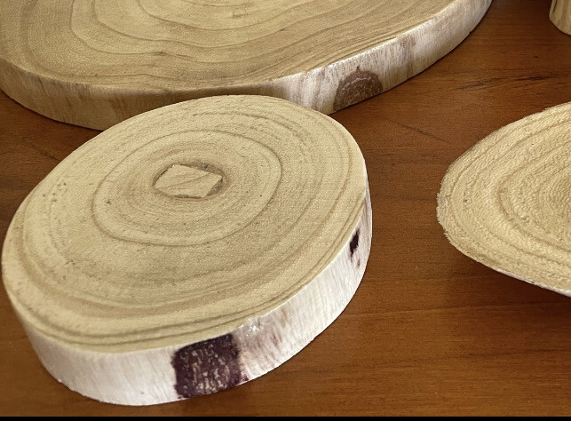 Small round varnished timber base