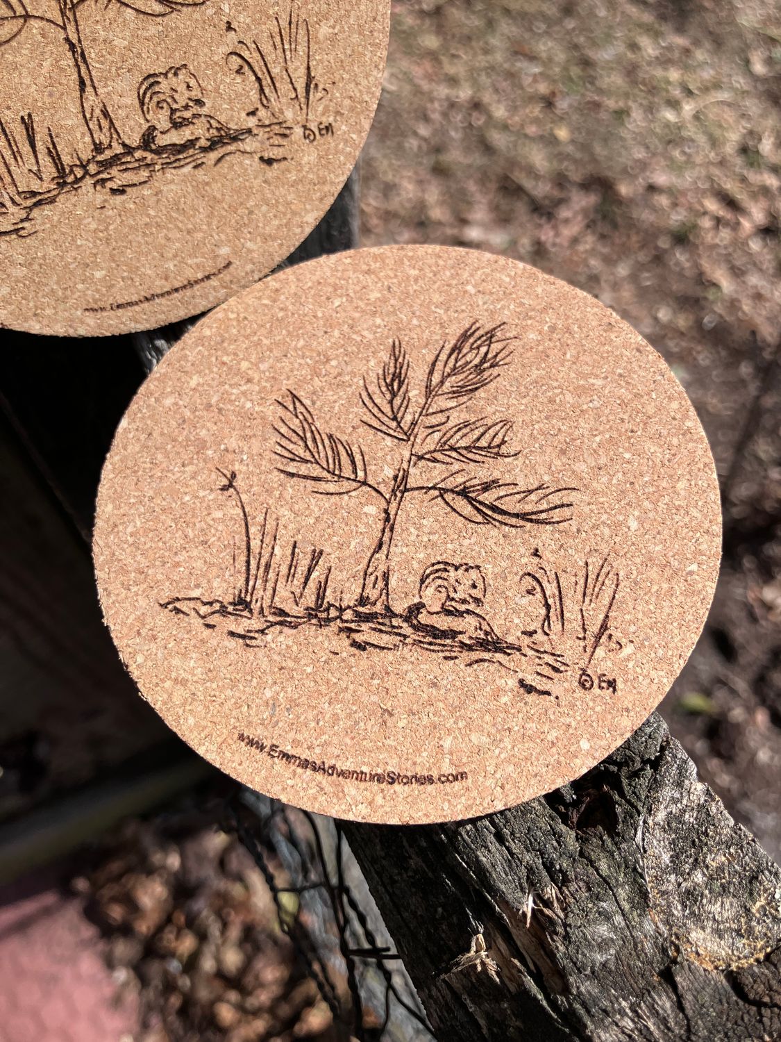 Set of Two Little Pine Tree Cork Coasters with the iconic pine tree and chipmunk from the first Emma book. Designed and laser engraved by us