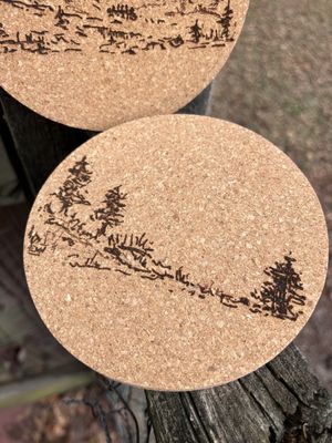 Set of Two Mountain and Woods Vista Coasters with designs from the trilogy. Designed and laser engraved by us Set of Two Mountain and Woods Vista Coasters with designs from the trilogy. Designed and laser engraved by us