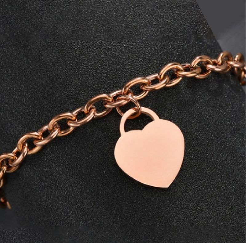 Pulsera con dije corazón oro rosa de acero inoxidable