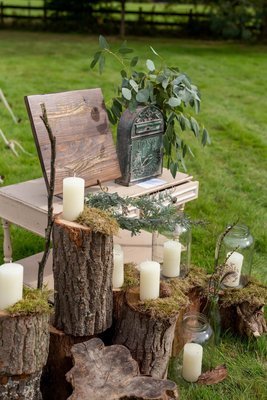 Log stack with pickling jars and chunky candles