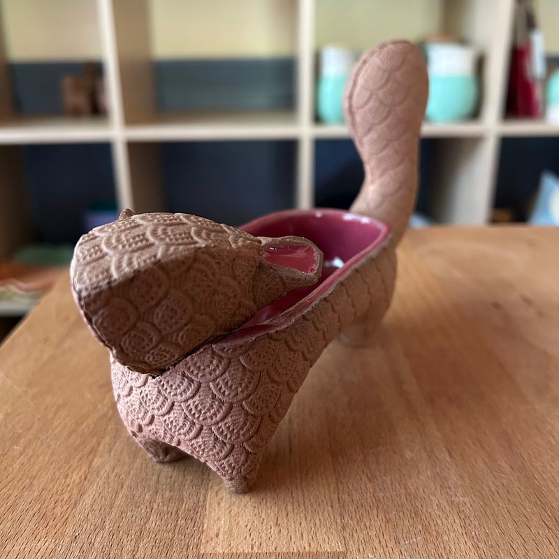 Small Squirrel in crimson and bare brown clay