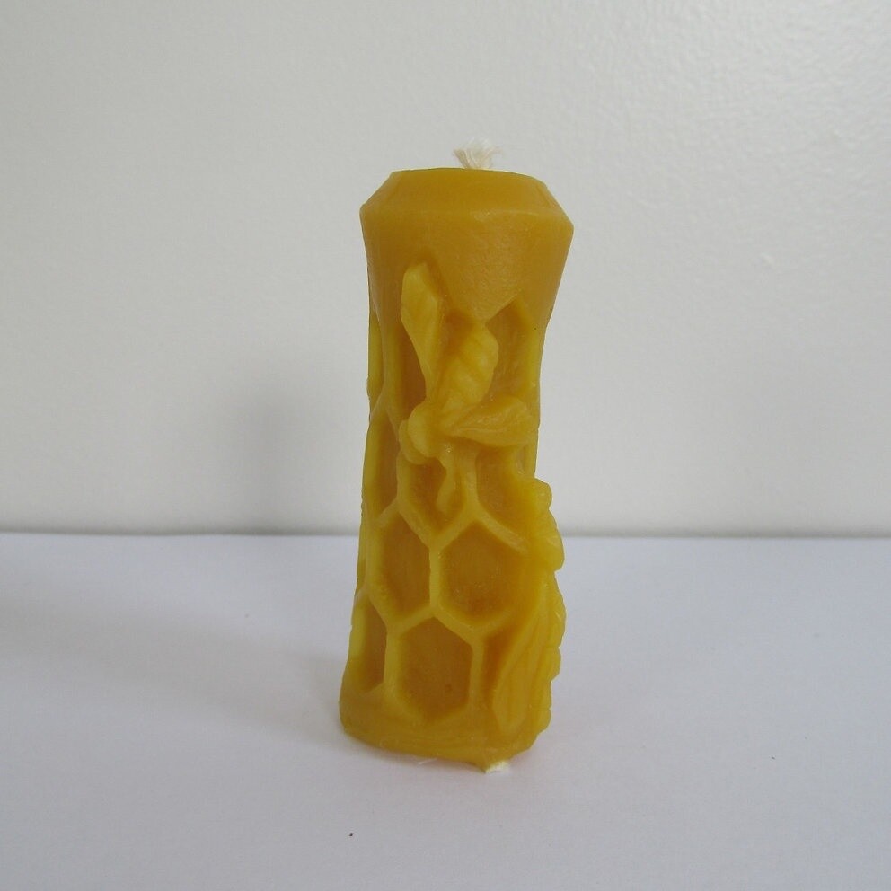 Candle with bee and honeycomb