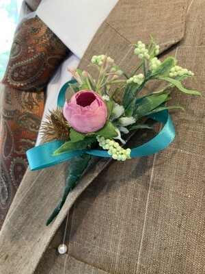 Vibrant handmade pink peony bud boutonniere with teal statement ribbon