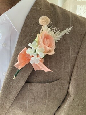 Delicate peach pink rose boutonniere