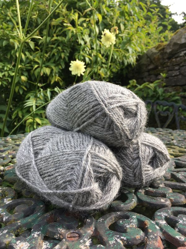 Ball of natural British Herdwick and Mule wool yarn spun from the fleeces of sheep at The Living Rug Company.