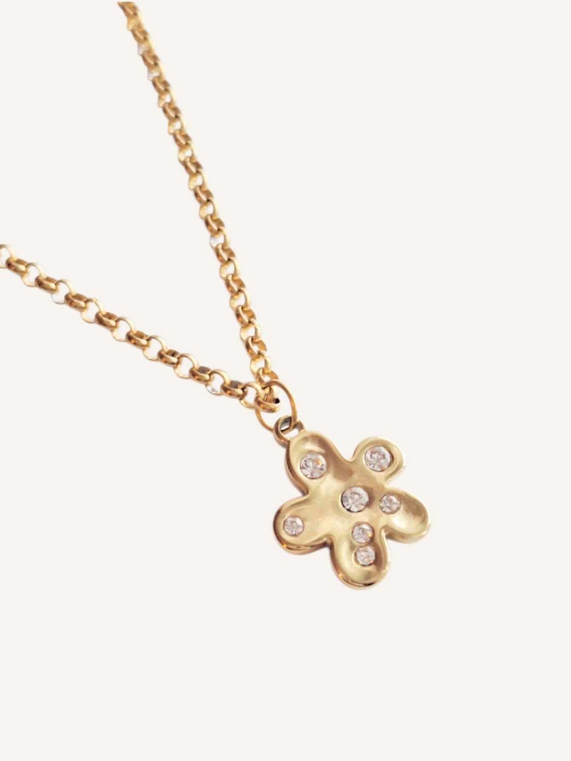 Goldene Kette mit einem auffälligen, unregelmäßigen Blumenanhänger  mit Zirkonia-Steinen verziert. Perfekt fürs Layering