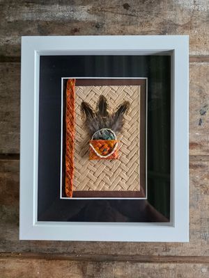 Orange mini-kete with feathers &amp; paua