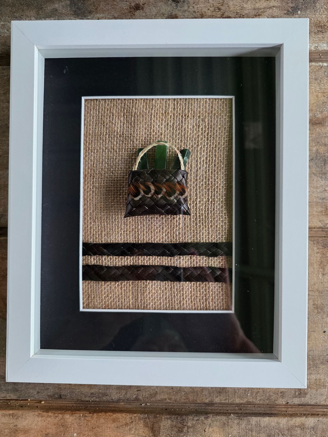 Dark brown mini-kete with pounamu (greenstone)