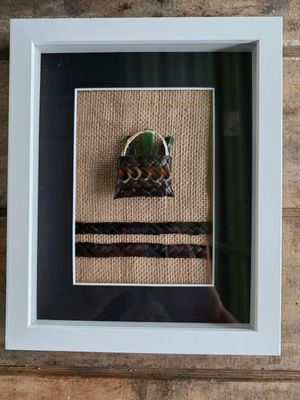 Dark brown mini-kete with pounamu (greenstone)