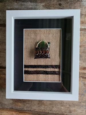 Dark brown mini-kete with pounamu (greenstone)