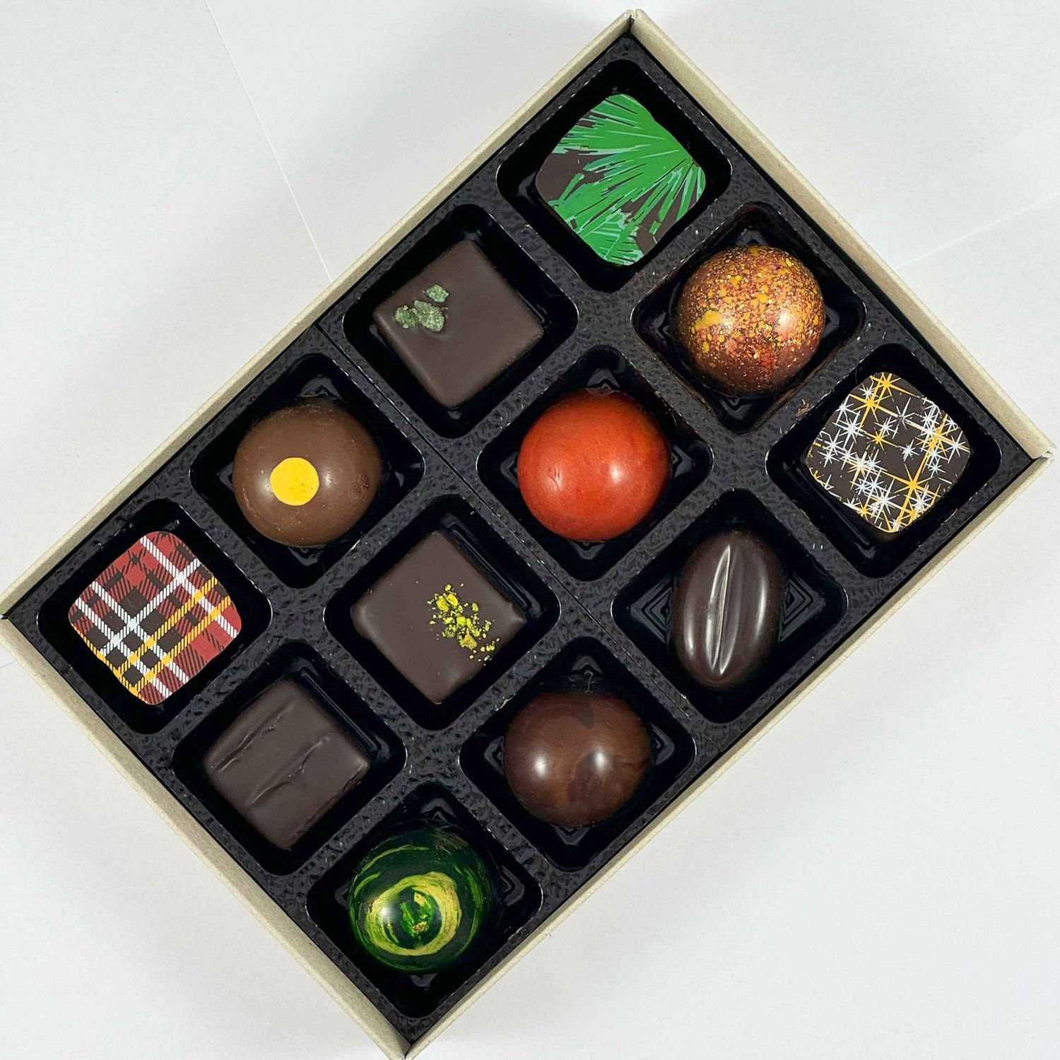 Gift box of 12 Artisan Chocolates - beautiful handmade chocolates made with only the best chocolate and fillings - no preservatives, so flavours are vibrant and real - packaged in an eco-friendly box