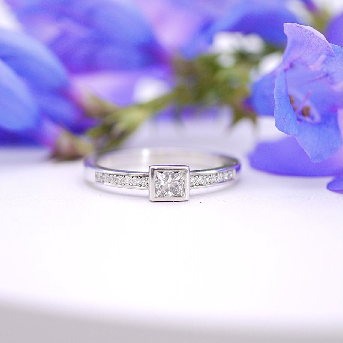 Princess-cut diamond  ring with pavé shoulders
