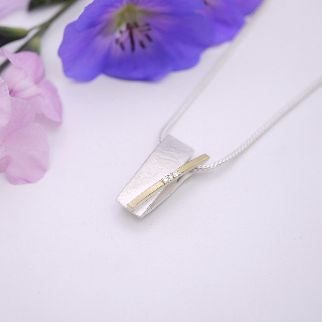 Crossover bar pendant with diamonds