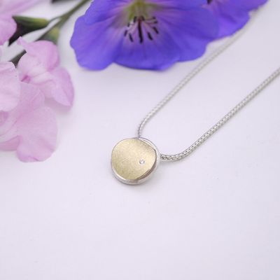 Puffed circle pendant with diamond