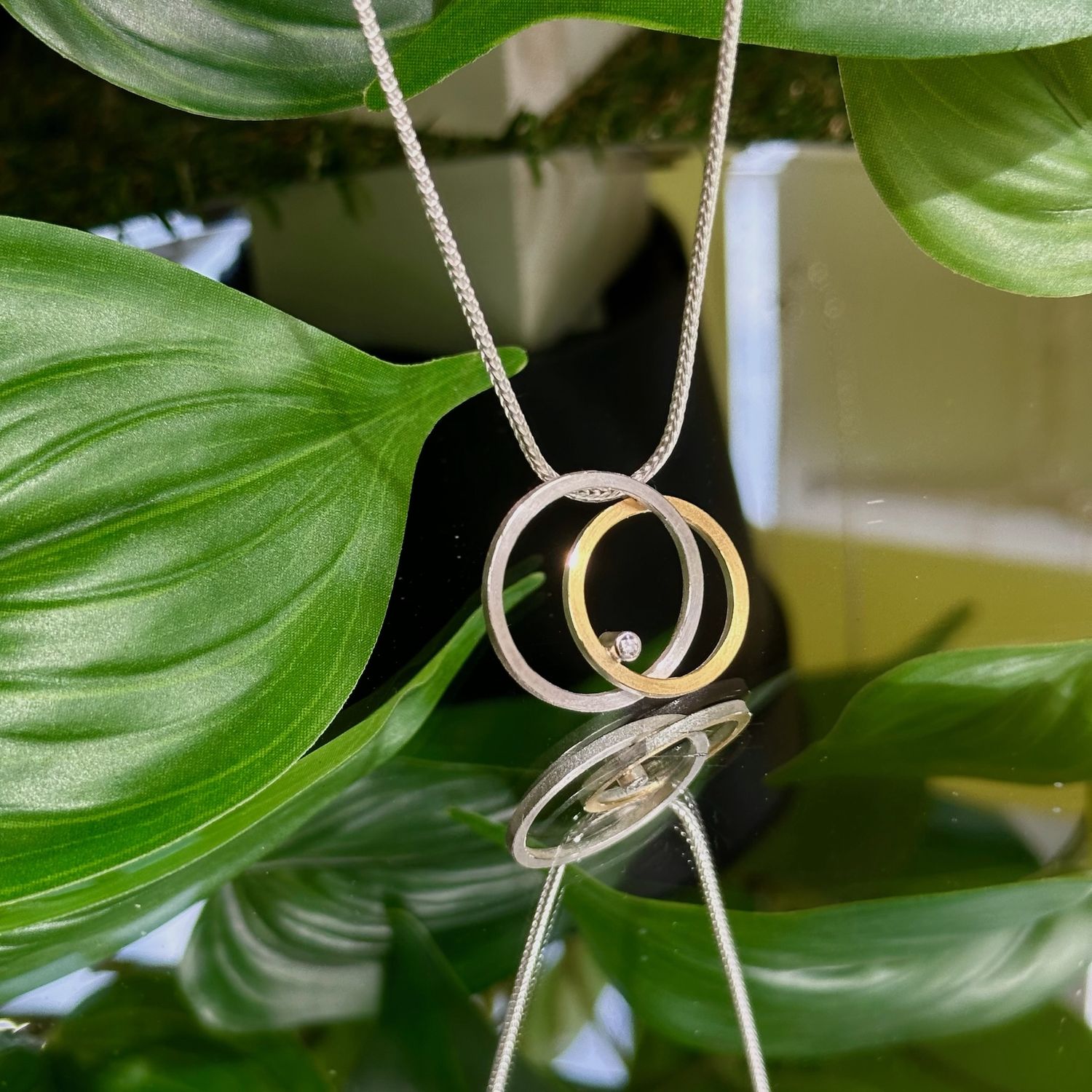 Interlocking circles pendant with diamond