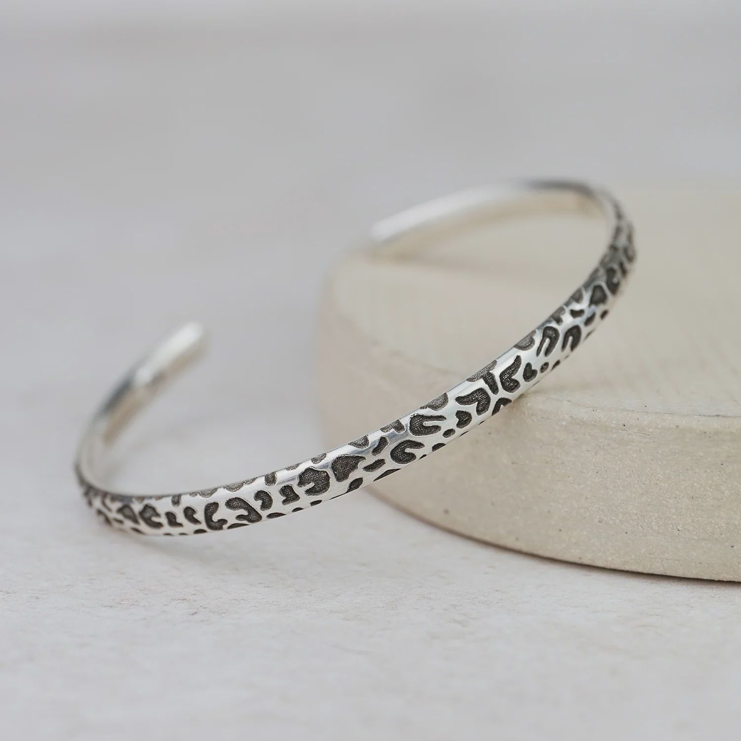 Textured cuff with leopard print pattern