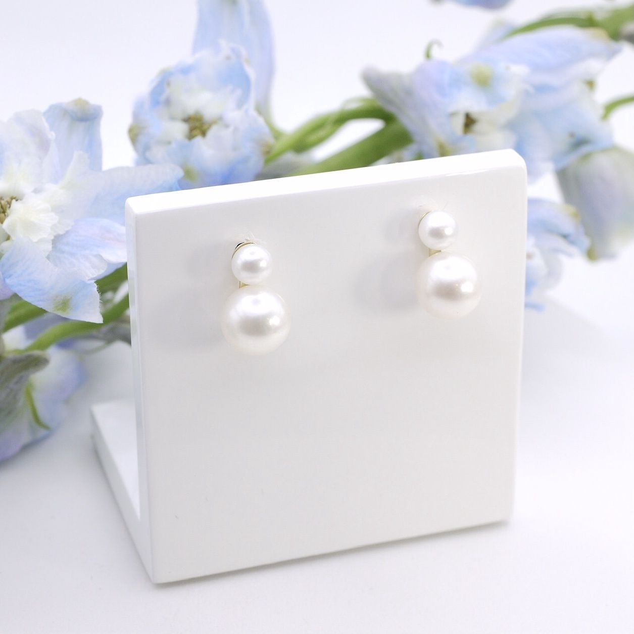 Double pearl drop studs in gold