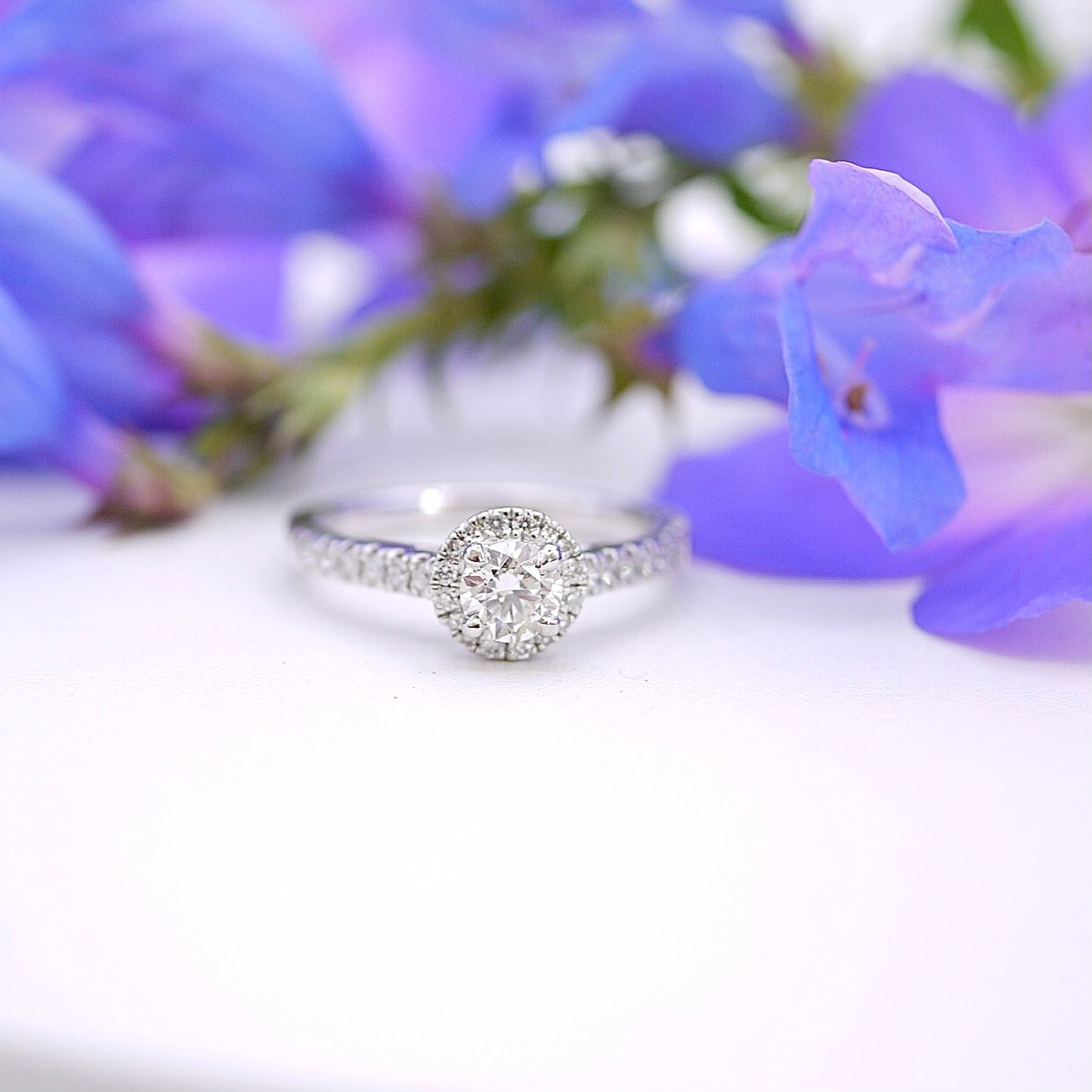 Diamond halo ring with pavé shoulders