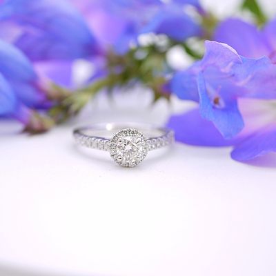 Diamond halo ring with pavé shoulders