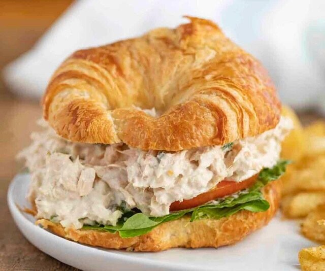Tuna salad with lettuce, tomato, and onion