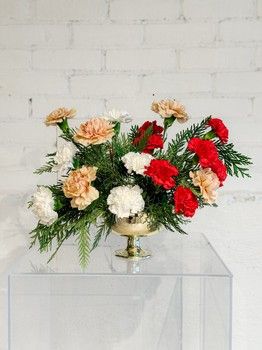 Crimson Canvas Christmas floral arrangement with red and cream carnations, greenery and gold bowl in St. John's NL