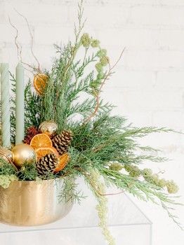 Evergreen Essence Christmas centrepiece with fresh greenery, candles and dried oranges by Teresa James Floral