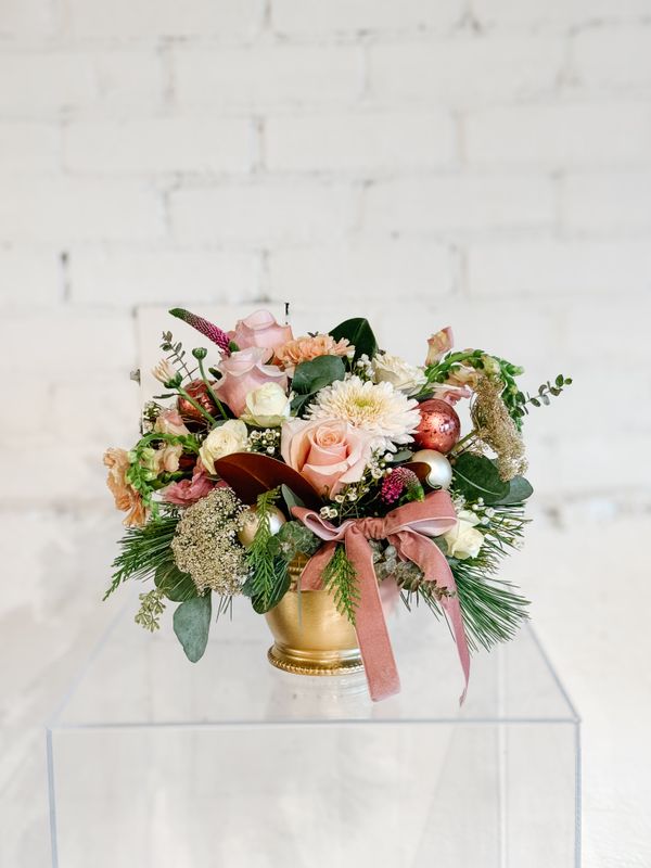 Blush &amp; Bright pink Christmas flower arrangement with roses and festive greenery by Teresa James Floral