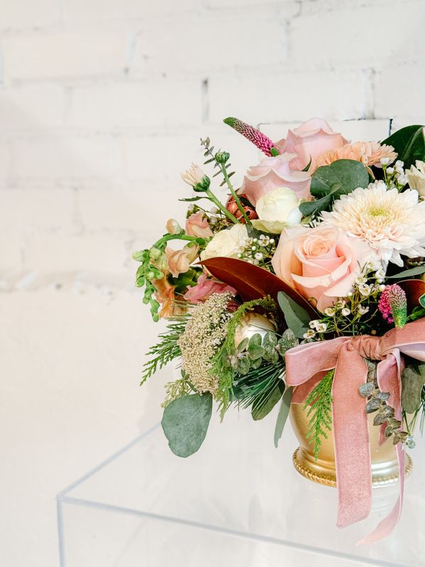 Close-up of soft pink roses, seasonal flowers and greenery in Blush &amp; Bright Christmas bouquet
