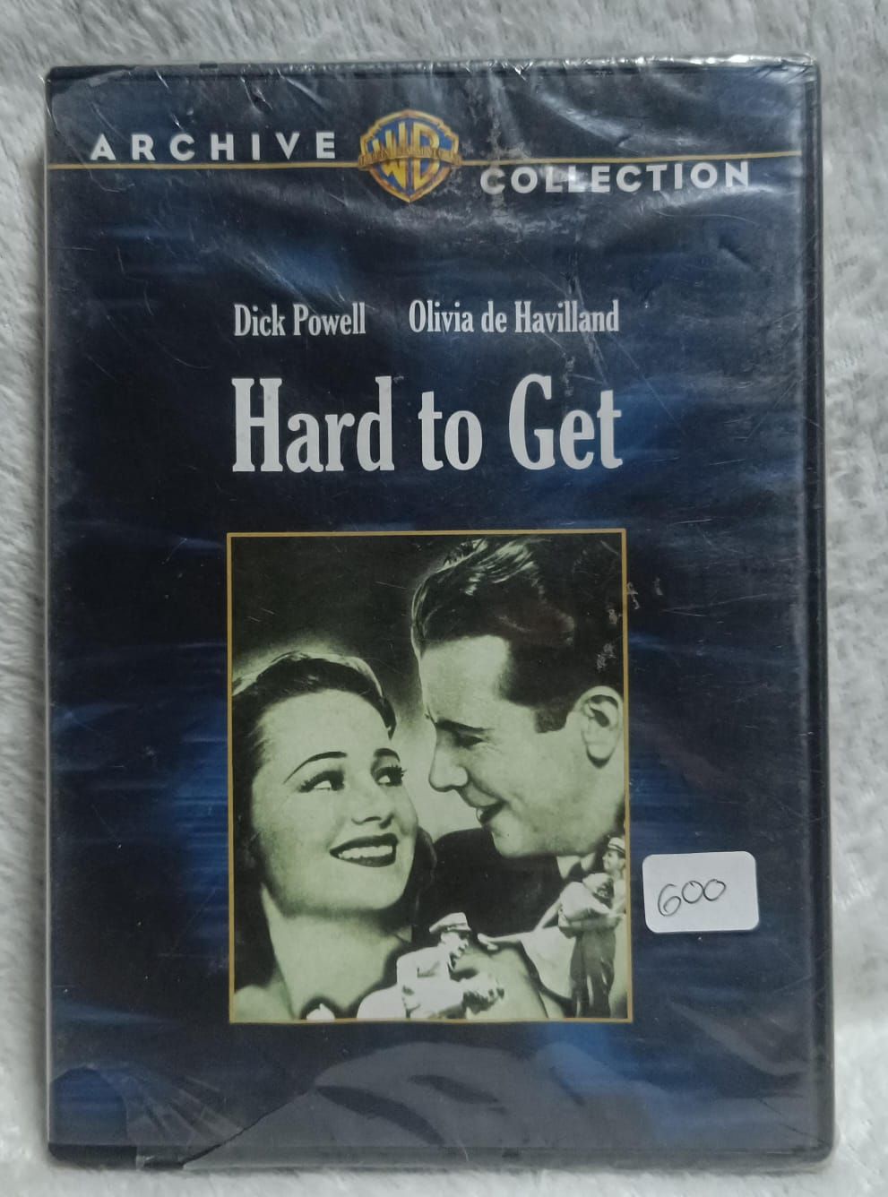 NELA-t, &quot;Hard to Get&quot; (1938), protagonizada por Dick Powell y Olivia.
