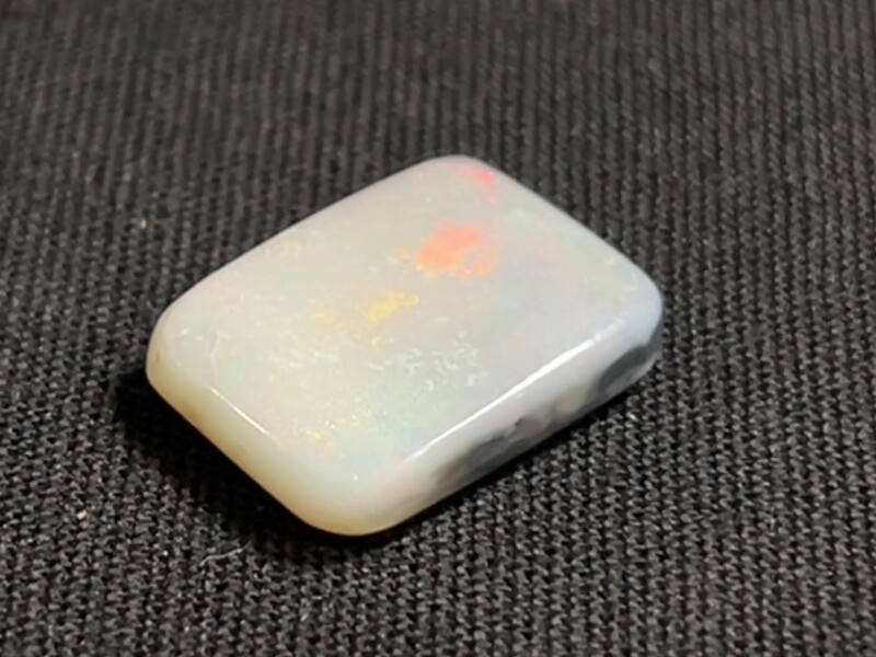 Large white opal with red, yellow, green and blue flashes