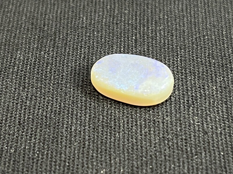 Dark crystal opal with purple, blue and green colour