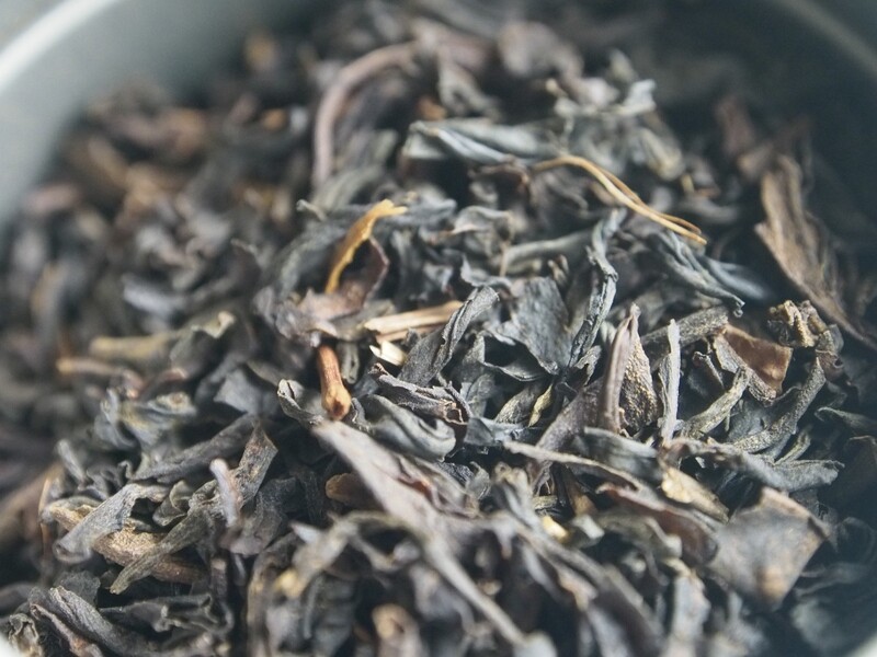A very close-up zoom of a pile of blended black teas.