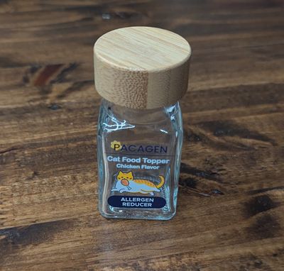 A small glass bottle with a wooden lid.