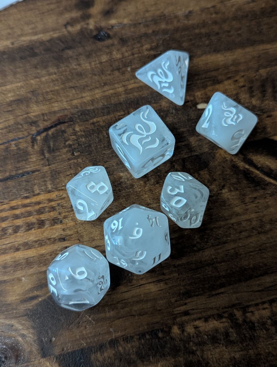 Cloudy white dice with white lettering, a symbol replacing the highest number.