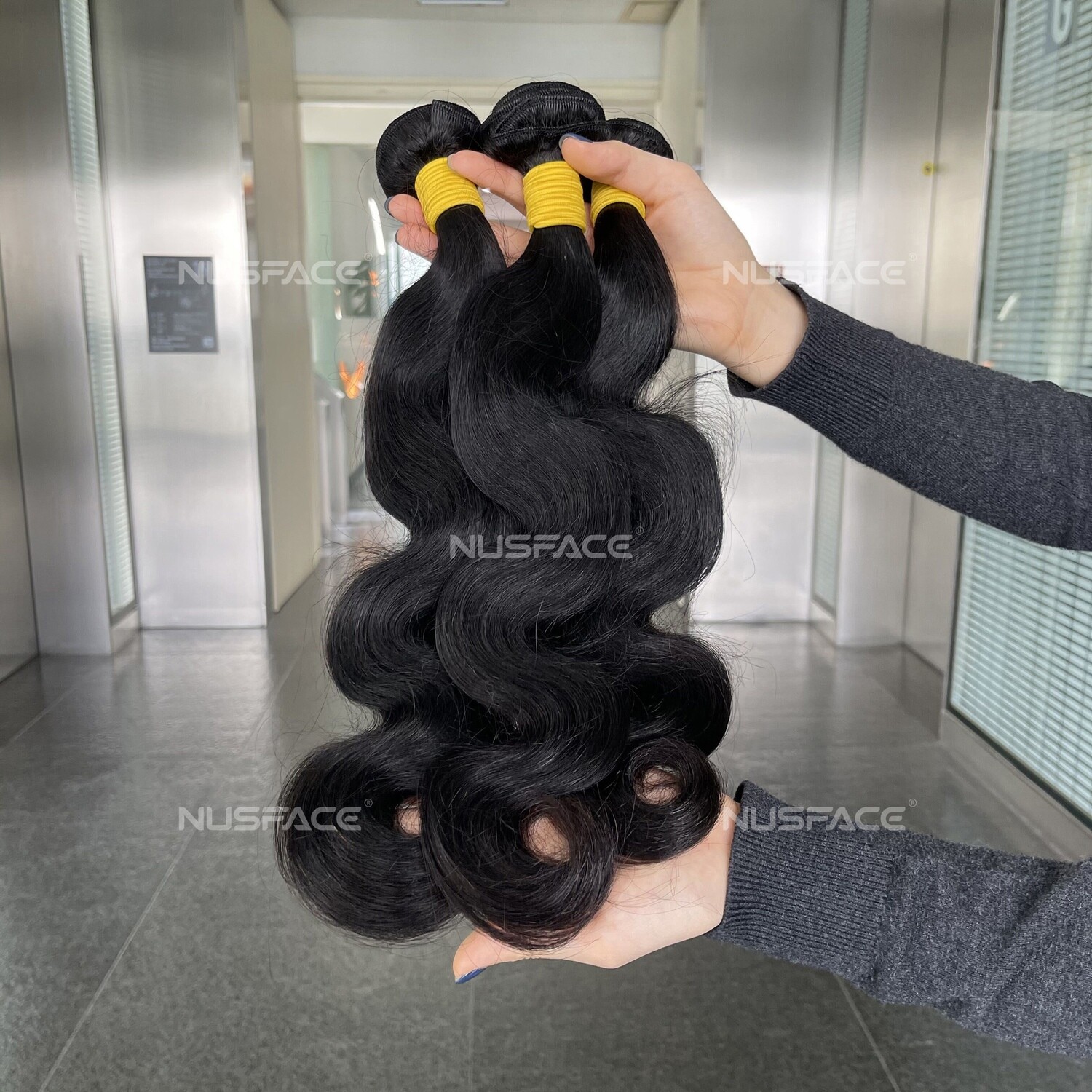 Natural hair extensions, bundles of raw Brazilian virgin human hair, 10 inches to 28 inches in length, priced between $45 and $180 a bundle.
