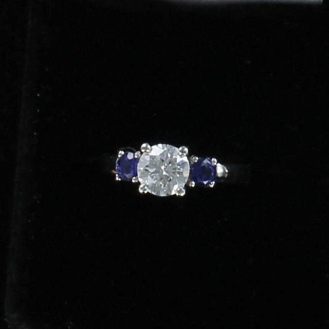 PLATINUM GIA CERTIFIED 1.30 CT ROUND BRILLIANT, SI1-F, WITH .68 CT SAPPHIRE ENGAGEMENT RING