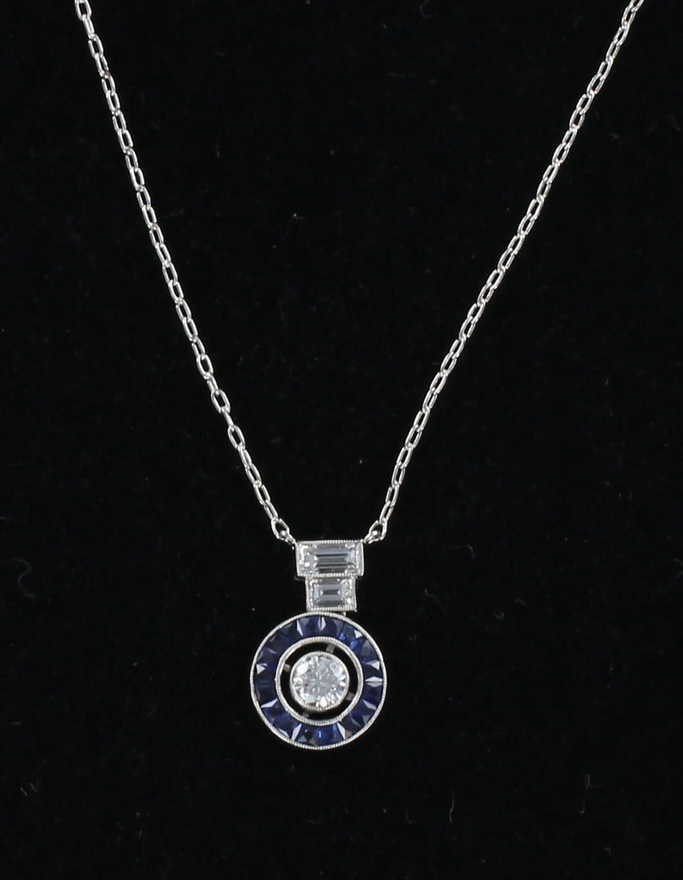 PLATINUM .25 CT ROUND DIAMOND SURROUNDED BY SAPPHIRES PENDANT