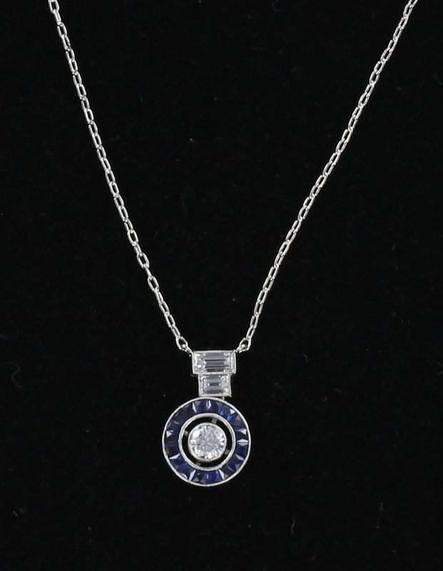 PLATINUM .25 CT ROUND DIAMOND SURROUNDED BY SAPPHIRES PENDANT
