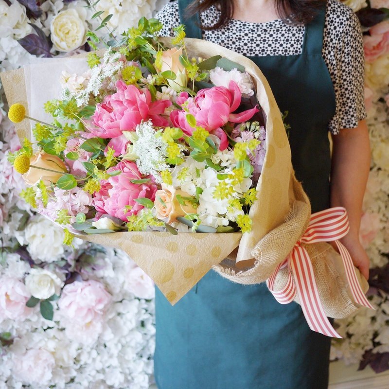 Holding bouquet colorful peony