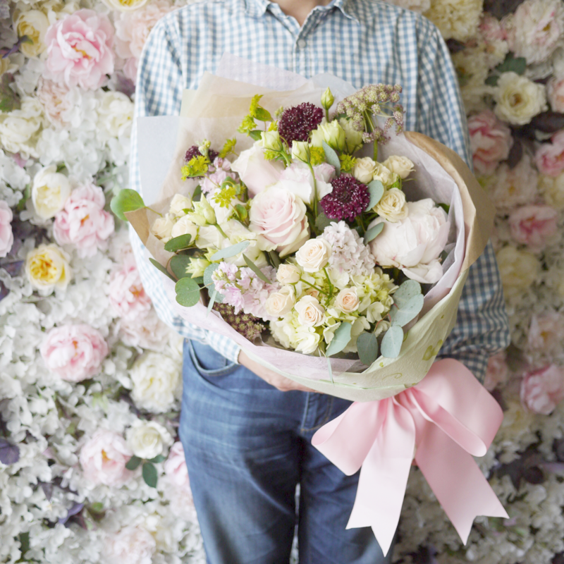 Holding bouquet pink peony