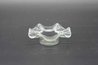 Picture of a clear wavy glass replacement bowl with a flat bottom for an aroma lamp. 