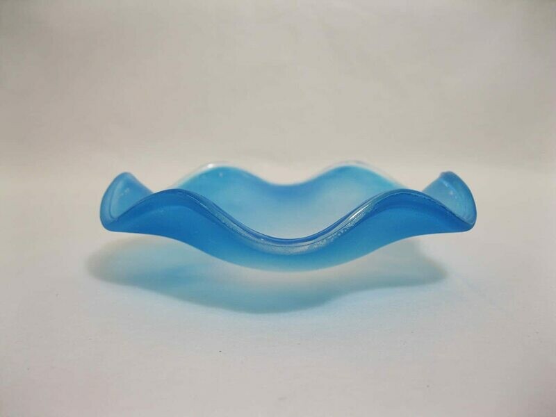 Picture of a frosted blue wavy glass replacement bowl for an aroma night light. 