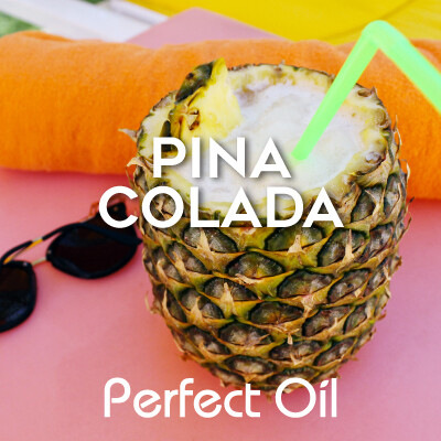 Picture showing an open top pineapple with a chunk of pineapple floating atop the pina colada inside with a green bent straw in the drink on top of a pink, orange and yellow blanket with the words pina colada and Perfect Oil in white on top of the image itself. 