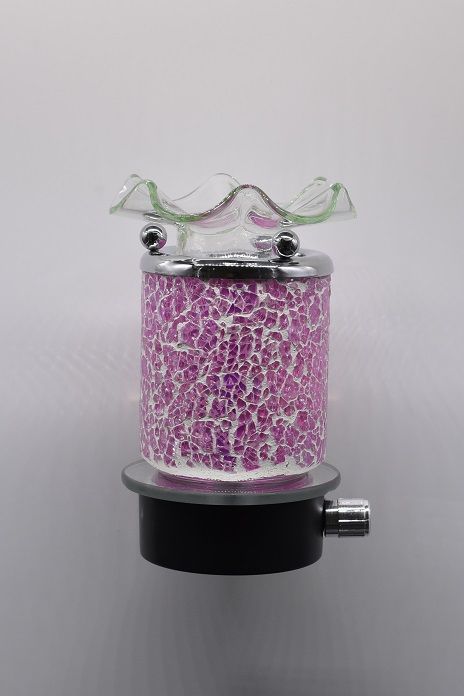 Picture showing a pink crackle glass aroma night light attached to a mirror topped black base and a silver dimmer switch on the right side of the base, and a silver rim on the pink portion supporting three silver balls which support a curly clear glass bowl on top.