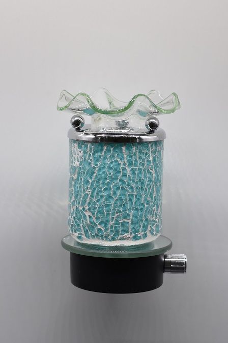 Picture showing an aqua crackle glass aroma night light attached to a mirror topped black base and a silver dimmer switch on the right side of the base, and a silver rim on the aqua portion supporting three silver balls which support a curly clear glass bowl on top.