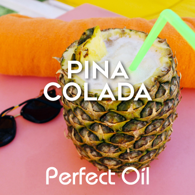 Picture showing an open top pineapple with a chunk of pineapple floating atop the pina colada inside with a green bent straw in the drink on top of a pink, orange and yellow blanket with the words pina colada and Perfect Oil in white on top of the image itself. 